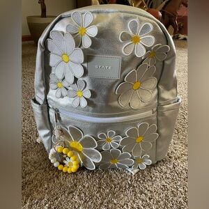 New without tags. STATE Kids' Metallic Backpack with Floral Daisy accent.